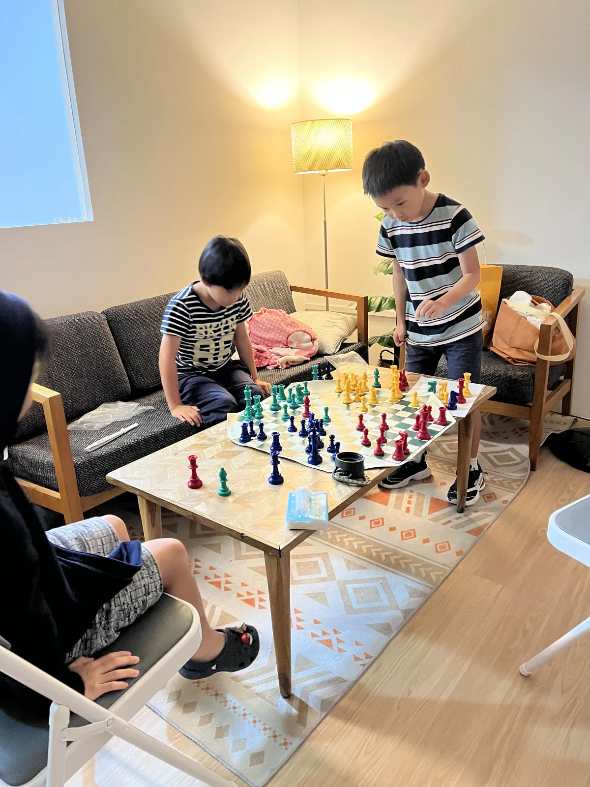 Young students exploring a colourful chess position together