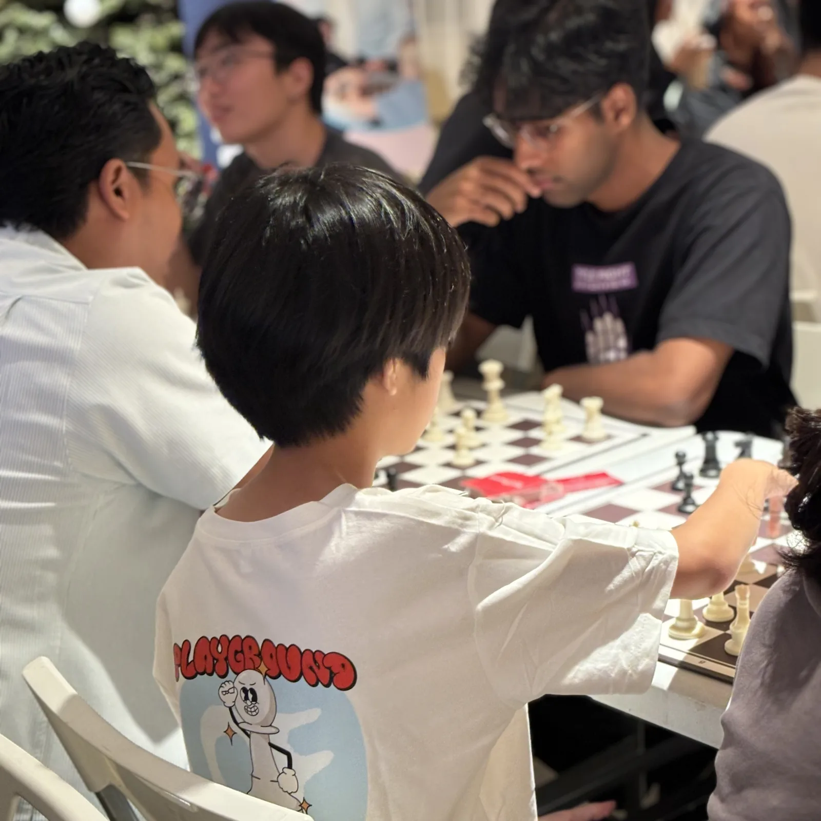 Students thinking together over a chessboard