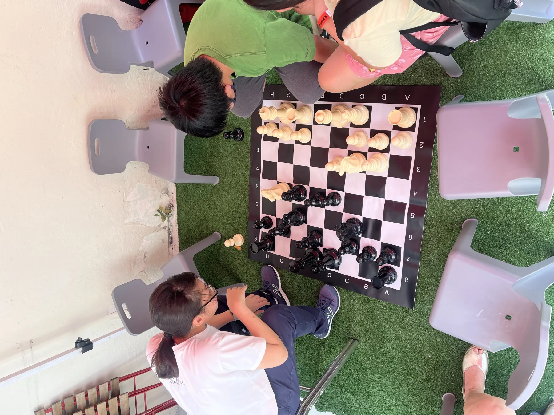 A child playing giant chess at the Aliwal World Chess Day Celebration