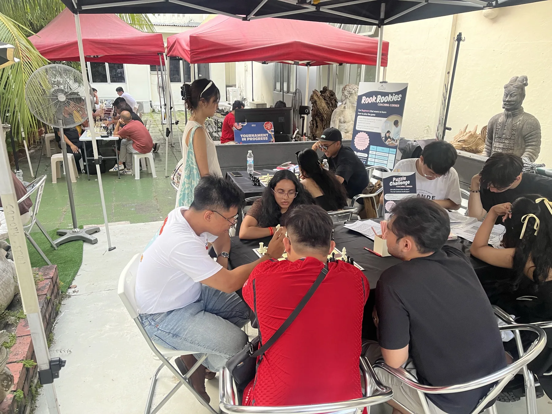 Visitors gathered around a chess puzzle activity station