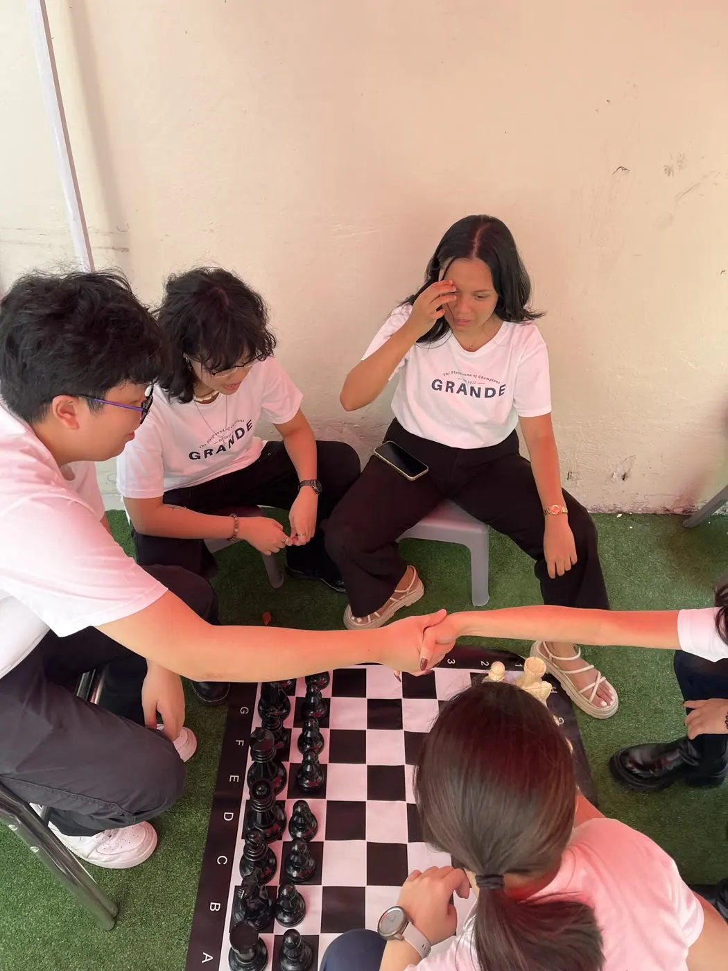 Children moving pieces on the giant chess board at Aliwal World Chess Day