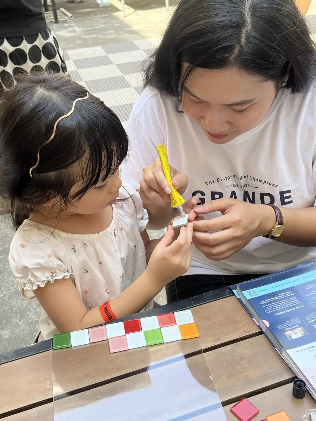 A child building a colourful chess set during the craft activity
