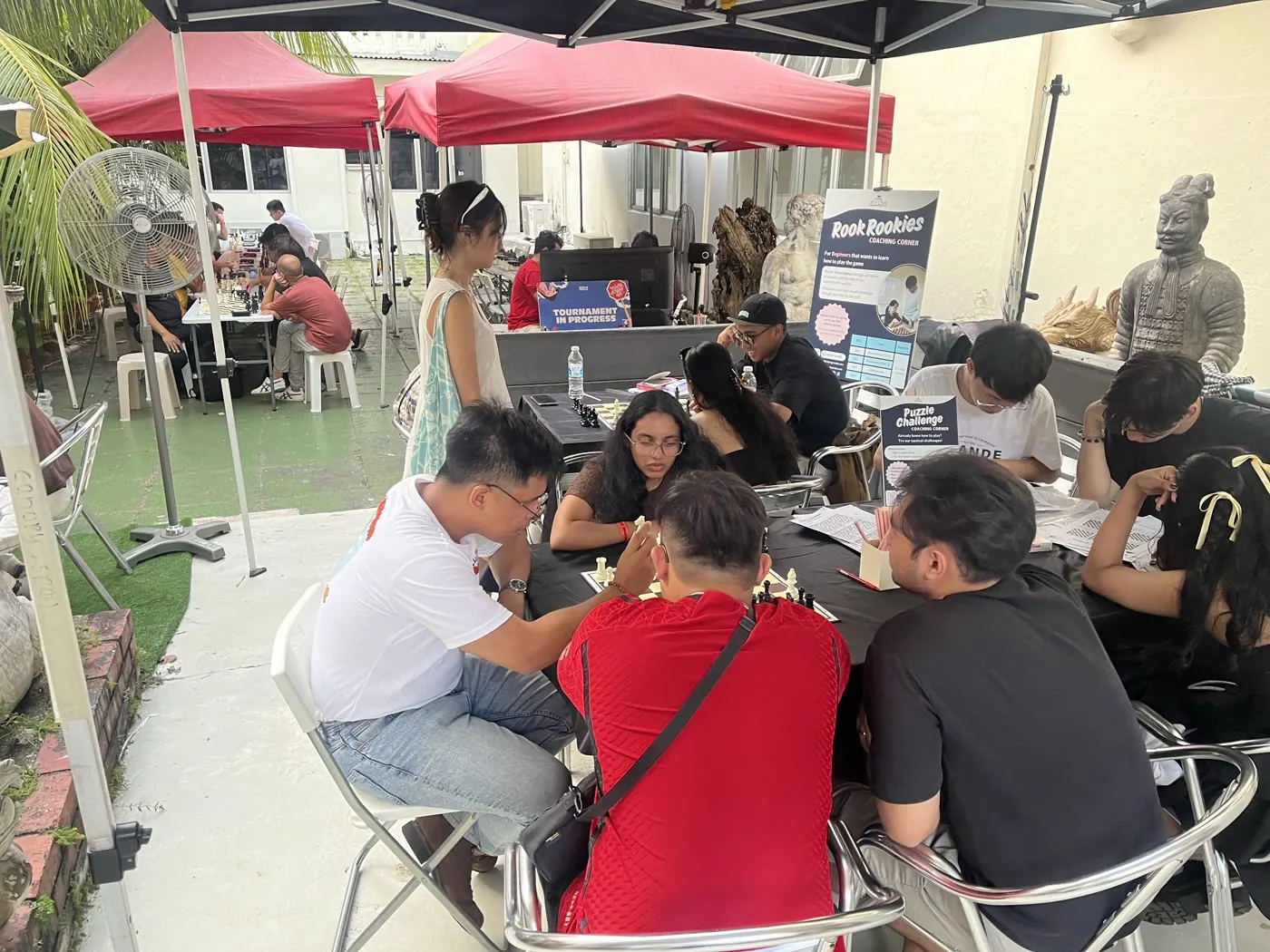 Families moving between chess activities at the public celebration