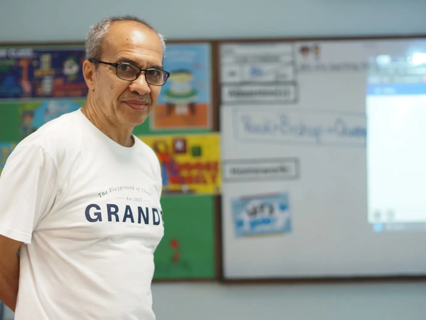 A Chess Grande team member helping students with a chess position