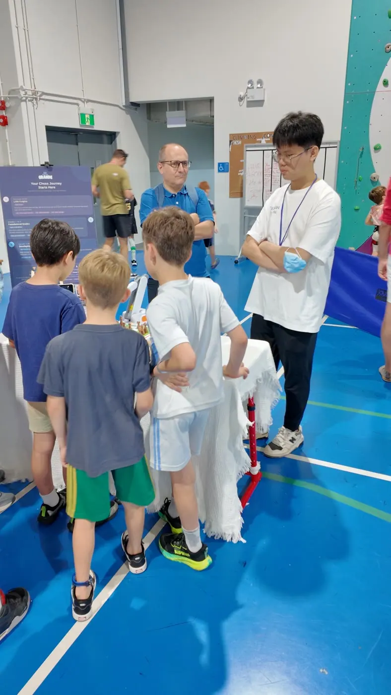 A child playing chess with a Chess Grande coach at Fête de l’École