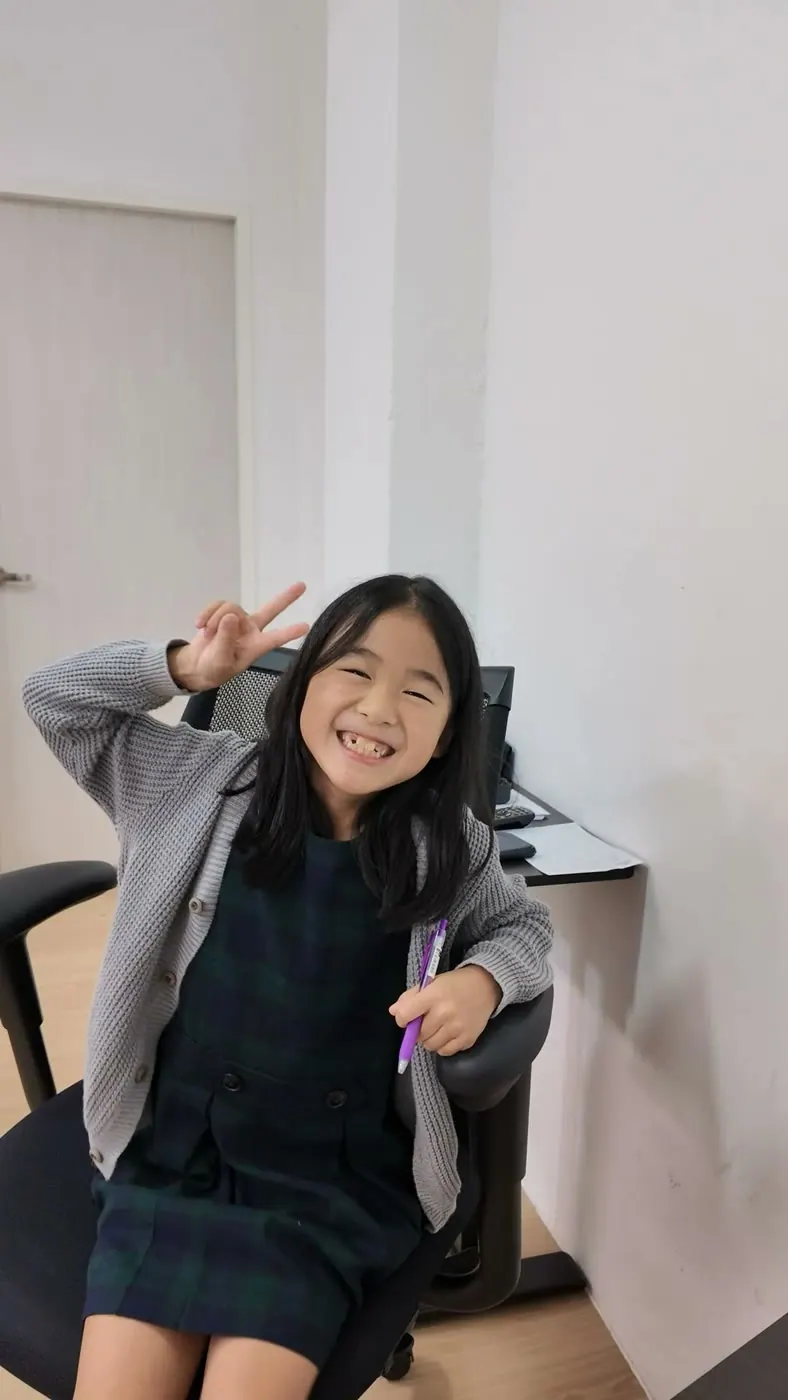A Season 1 participant smiling between chess games