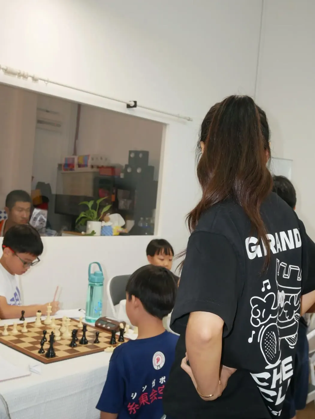 A Chess Grande team member observing games during the meetup