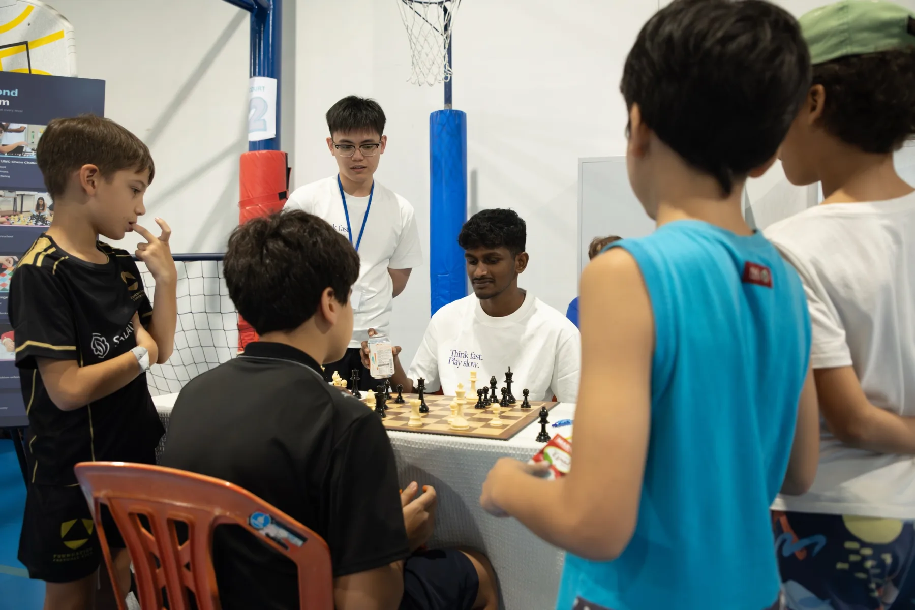 Families gathered around a Chess Grande coach for friendly games