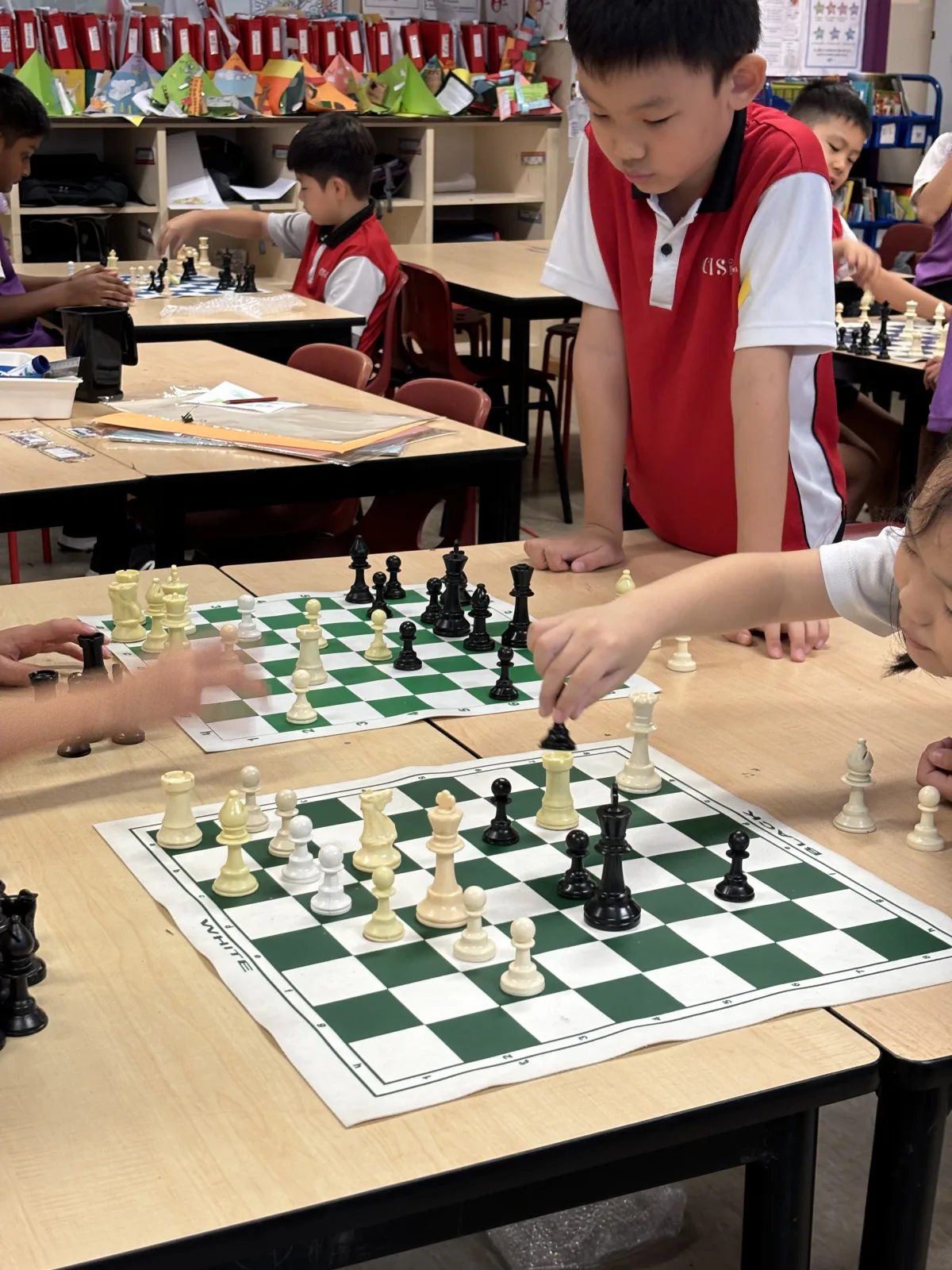 Canadian International School students playing chess during their CCA