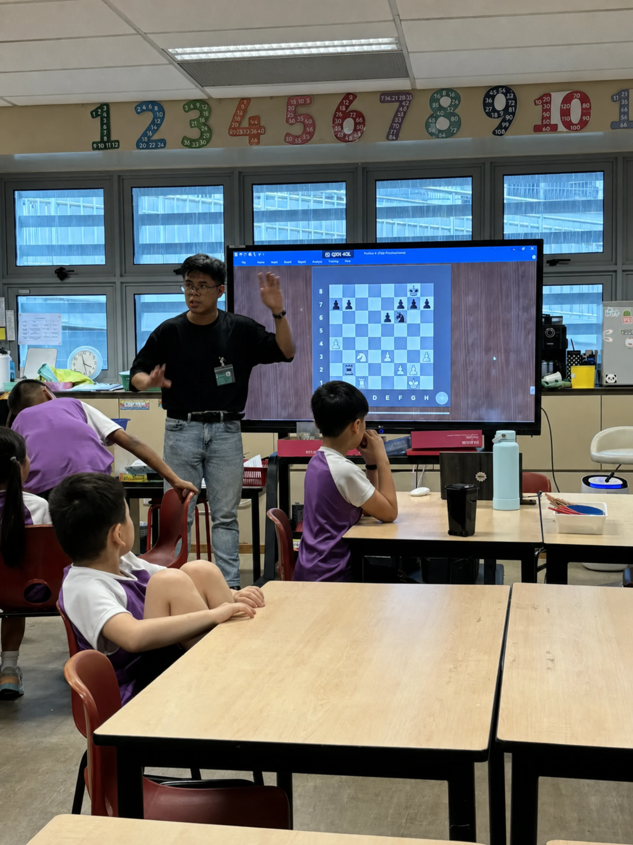 A Chess Grande coach guiding students through a chess position at Canadian International School