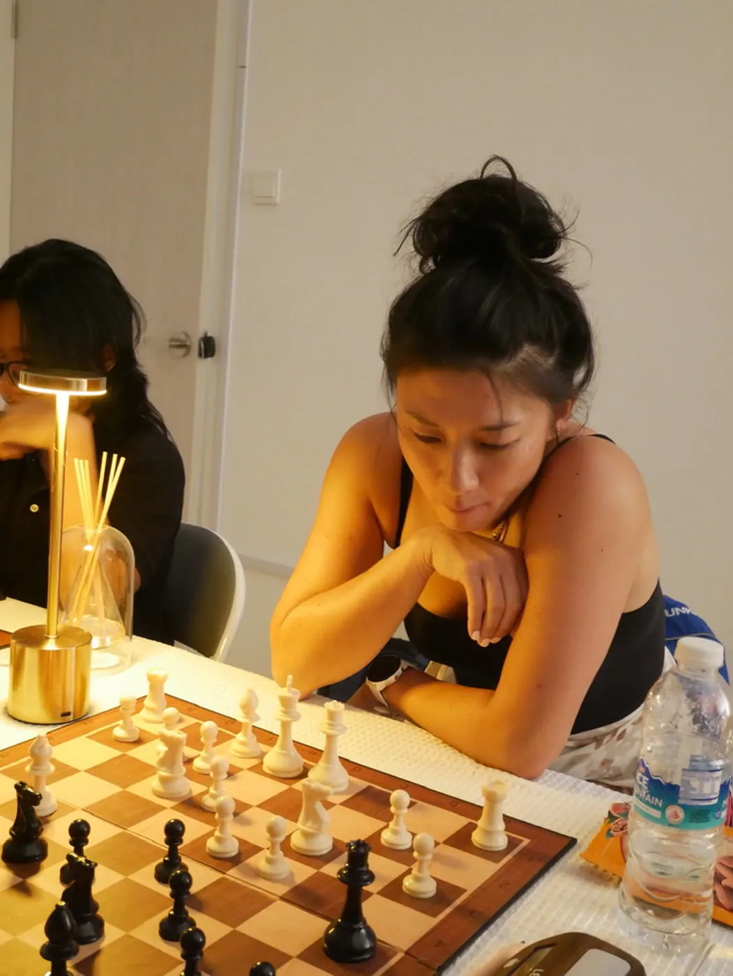 A player concentrating over her position at Checkmate and Chill