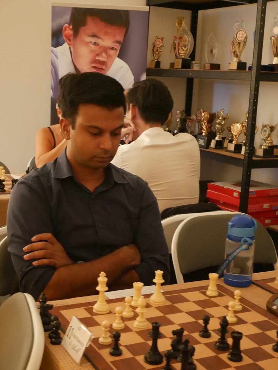 A participant considering his next move during the social chess event