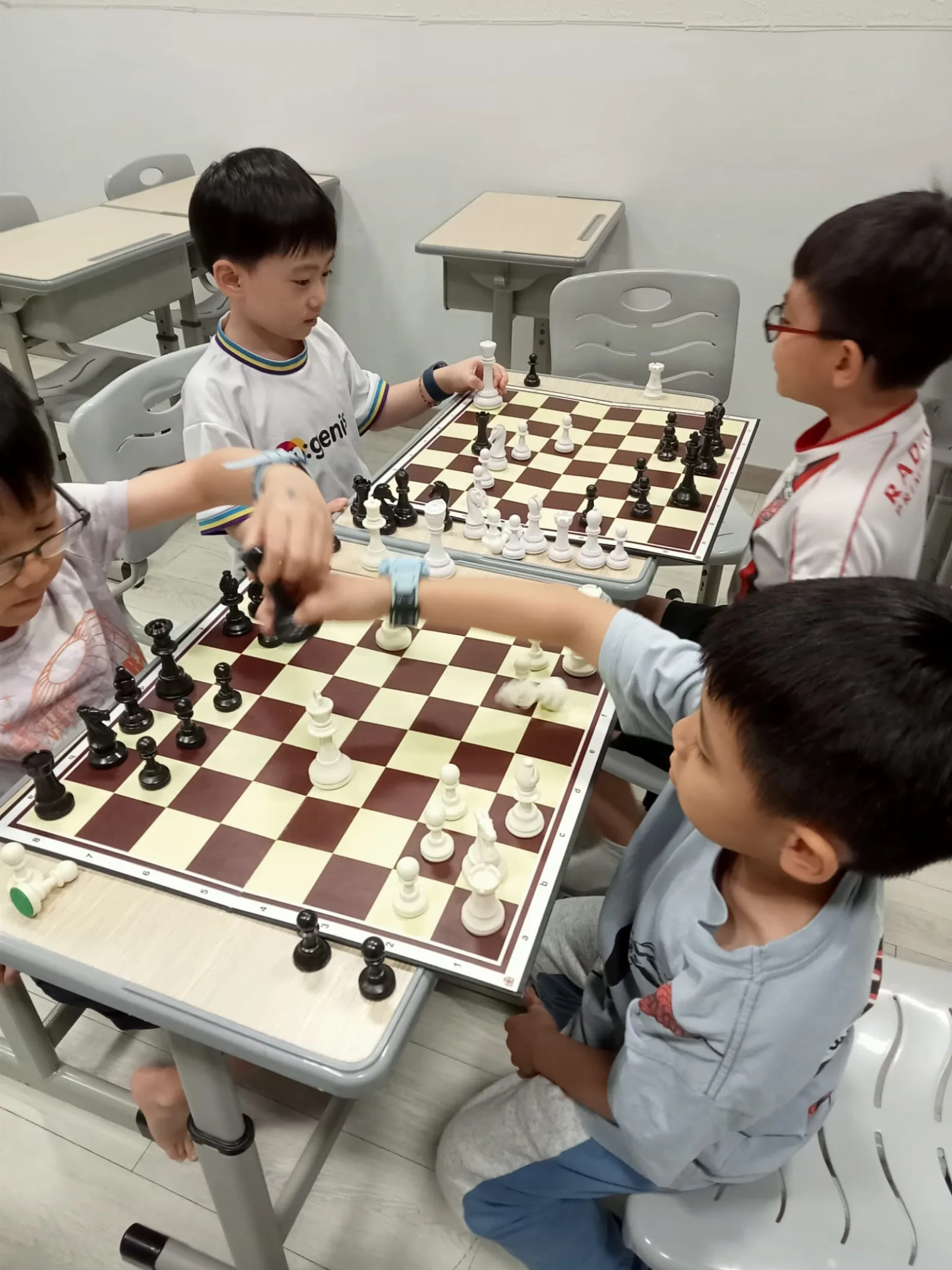 Children playing chess together during an Ingenius school camp