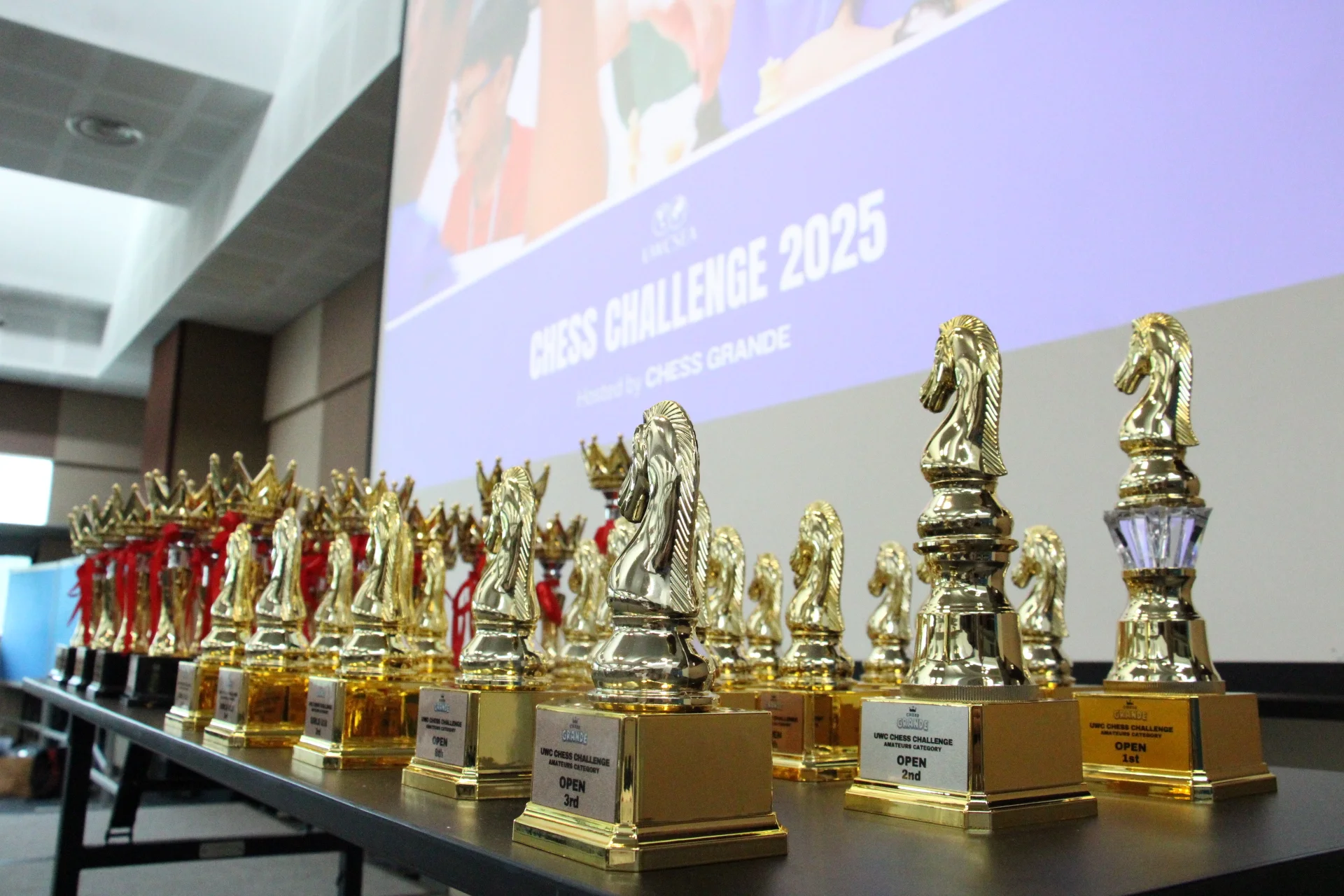 Chess-piece trophies arranged for the UWC Chess Challenge 2025