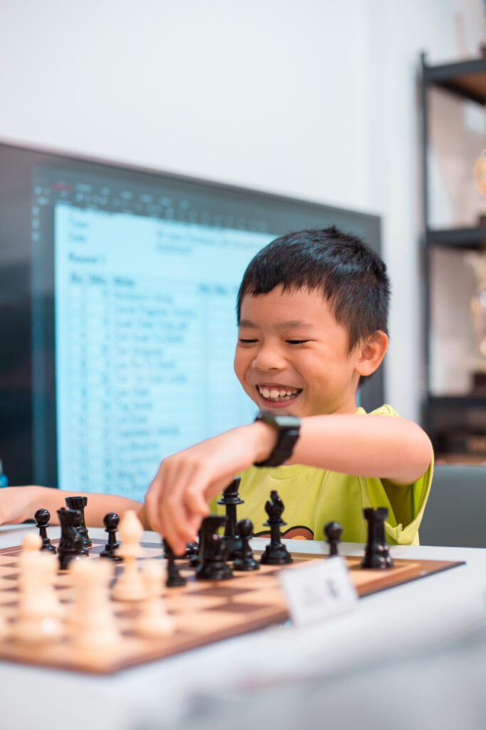 A young Chess Grande student enjoying a game during practice.