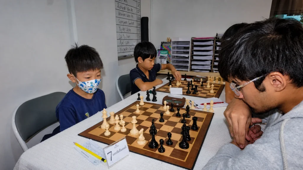 Young players compete across several chessboards during the 4th Chess Grande Invitationals.